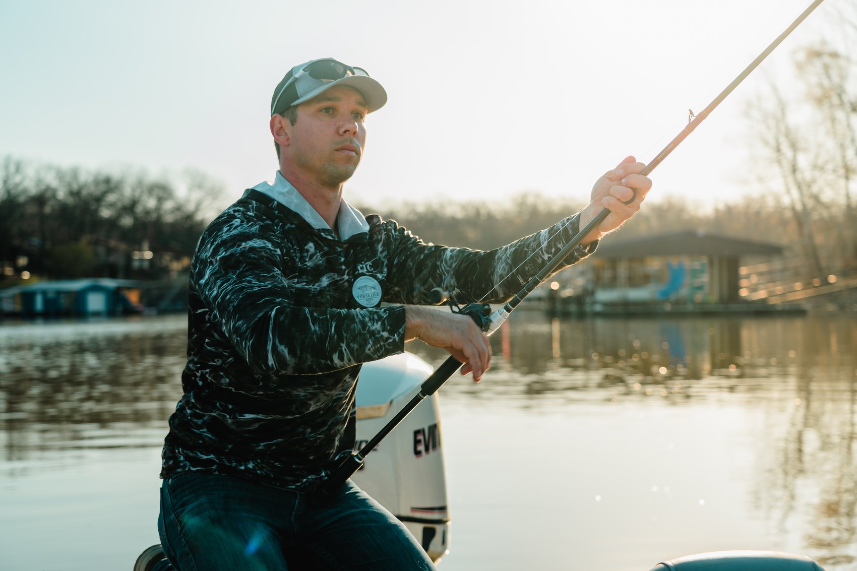 Eric fishing a Versatile Baits glide bait from the boat at sunset